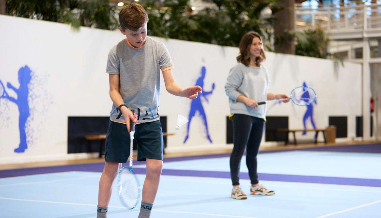 Lady and a young boy playing Badminton