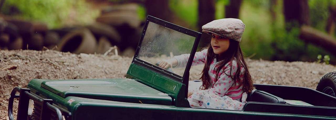 A little girl riding in an off road explorer