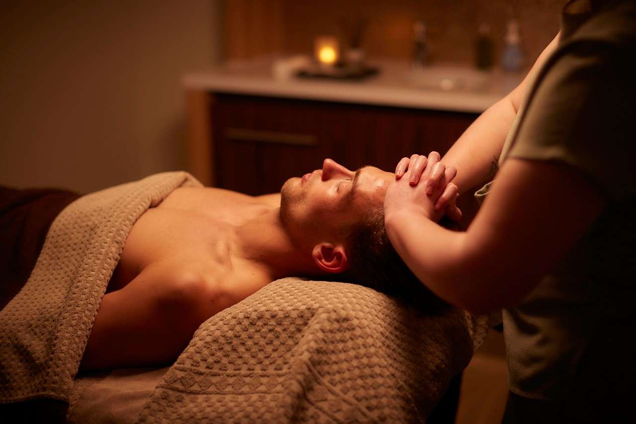 Spa performing a scalp treatment.
