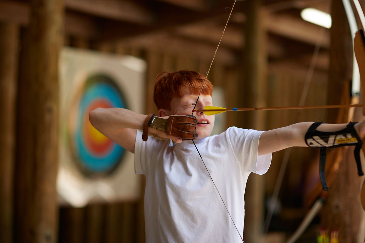 Boy practicing his archery skills.